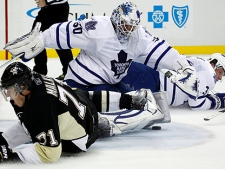 Pittsburgh Penguins' Evgeni Malkin (71), of Russia, slides into Toronto Maple Leafs  goalie Jonas Gustavsson (50) of Sweden after being brought down by defenseman Dion Phaneuf (3) on a breakaway in the second period of an NHL hockey game in Pittsburgh on Wednesday, Oct. 13, 2010. Malkin was awarded a penalty shot, but did not score. The Maple Leafs won 4-3. (AP Photo/Gene J. Puskar)