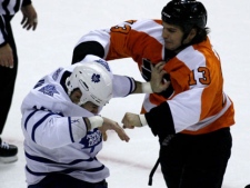 Toronto Maple Leafs' Mike Brown, left, and Philadelphia Flyers' Daniel Carcillo (13) fight in the first period of an NHL hockey game Saturday, Oct. 23, 2010, in Philadelphia. (AP Photo/H. Rumph, Jr.)