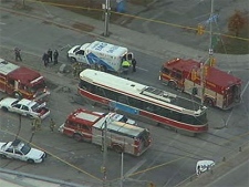 Emergency crews surround a streetcar after a cyclist was struck and killed Friday morning. 