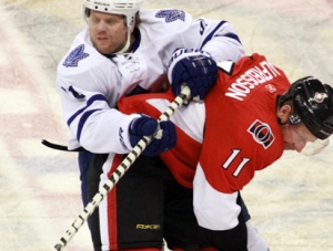 Toronto Maple Leafs' Phil Kessel (81) is checked by Ottawa Senators' Daniel Alfredsson (11) during first period NHL hockey action in Ottawa on Saturday Nov. 27, 2010. (AP Photo/The Canadian Press, Fred Chartrand)