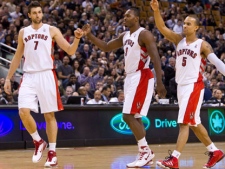 Toronto Raptors, from left to right, Andrea Bargnani, Joey Dorsey, and Jerryd Bayless celebrate during first half NBA basketball action against the Washington Wizards in Toronto Wednesday, December 1, 2010. The Raptors defeated the Wizards 127-108. (THE CANADIAN PRESS/Darren Calabrese)