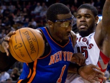 New York Knicks  Amare Stoudemire (left) drives by Toronto Raptors'  Amir Johnson  during first half NBA basketball action in Toronto Sunday, December 5, 2010. THE CANADIAN PRESS/Chris Young