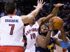 Toronto Raptors forwards Andrea Bargnani (7) and DeMar DeRozan (10) put pressure on Denver Nuggets forward Nene, right, during first half NBA basketball action in Toronto on Friday, December 10, 2010. (THE CANADIAN PRESS/Nathan Denette)