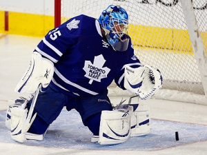 Toronto Maple Leafs goalie Jean-Sebastien Giguere watches the puck pass through the crease during second period NHL hockey action against the Calgary Flames in Calgary, Alta., Thursday, Dec. 16, 2010.(THE CANADIAN PRESS/Jeff McIntosh)