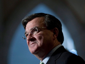 Minister of Finance Jim Flaherty speaks with media in the foyerof the House of Commons on Parliament Hill in Ottawa, Thursday December 16, 2010. (THE CANADIAN PRESS/Adrian Wyld)