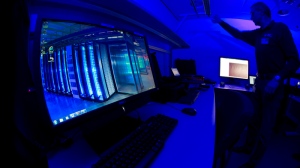 A member of the Cybercrime Center turns on the light in a lab during a media tour at the occasion of the official opening of the Cybercrime Center at Europol headquarters in The Hague, Netherlands, Friday Jan. 11, 2013. (AP / Peter Dejong)