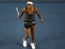 Venus Williams of the U.S. reacts before she withdrew from her third round match against Germany's Andrea Petkovic injured at the Australian Open tennis championships in Melbourne, Australia, Friday, Jan. 21, 2011. (AP Photo/John Donegan)