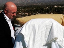 In this photo provided by the office of U.S. Rep Gabrielle Giffords, Giffords' husband, Mark Kelly, stands with his wife as she looks from her bed at the Santa Catalina Mountains while on an outdoor deck at University Medical Center in Tucson, Ariz., Thursday, Jan. 20, 2011.