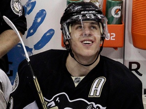 Pittsburgh Penguins' Evgeni Malkin, of Russia, sits on the bench between shifts during the third period of an NHL hockey game against the Phoenix Coyotes in Pittsburgh on Monday, Dec. 20, 2010. Malkin had five points in a 6-1 Penguins win. (AP Photo/Gene J. Puskar)