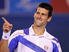 Novak Djokovic gestures to his supporters as he celebrates his win over Roger Federer in their semifinal at the Australian Open tennis championships in Melbourne, Australia on Thursday, Jan. 27, 2011. (AP Photo/Mark Baker)