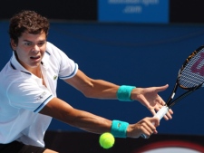 Milos Raonic of Canada returns a ball to Michael Llodra of France during their second round match at the Australian Open tennis championships in Melbourne, Australia on Thursday, Jan. 20, 2011. (AP/John Donegan)