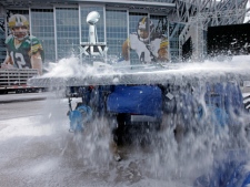 Workers clear snow off a stage outside Cowboys Stadium in preparation for Super Bowl XLV on Tuesday, Feb. 1, 2011, in Arlington, Texas. (AP/David J. Phillip)