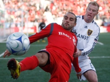 Toronto FC's Dwayne De Rosario, left, battles for the ball against Real Salt Lake player Nat Borchers during an MLS soccer game in Toronto on Saturday, Oct. 17, 2009. (THE CANADIAN PRESS/Nathan Denette)