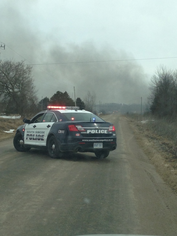 A police vehicle is shown at the scene of an Innisfil fire that sent toxic black smoke billowing into the air Monday March 18, 2013. (Mike Walker/ CTV Barrie)