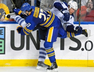 Buffalo Sabres defenseman Shaone Morrisonn, left, checks Toronto Maple Leafs defenseman Mike Komisarek into the boards during the third period of an NHL hockey game in Buffalo, N.Y. on Saturday, Feb. 5, 2011. Buffalo won 6-2.  (AP Photo/Don Heupel)