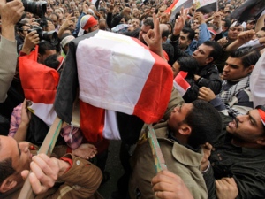 People carry a symbolic coffin of Egyptian journalist Ahmed Mohammed Mahmoud in a symbolic funeral ceremony in Cairo, Egypt on Monday, Feb. 7, 2011. The reporter died of his wounds a week after being shot during clashes, his employer said. (AP Photo/Ben Curtis)