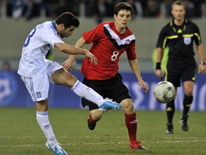 Greece's Giannis Fetfatzidis, left, shoot to score during a friendly soccer game against Canada in Larissa, Greece, on Wednesday Feb, 9, 2011. (AP Photo/Nikolas Giakoumidis)