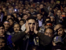 Anti-government protesters watch on a big screen as Egyptian President Hosni Mubarak makes a televised statement to his nation in Tahrir Square in downtown Cairo, Egypt, on Thursday, Feb. 10, 2011. Protesters, hoping Mubarak would announce his resignation outright, reacted in fury and disbelief. (AP Photo/Emilio Morenatti)