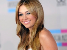 Miley Cyrus arrives at the 38th Annual American Music Awards on Sunday, Nov. 21, 2010 in Los Angeles. (AP / Chris Pizzello)