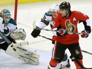 San Jose Sharks goaltender Antti Niemi makes a stick save as Ottawa Senators forward Mike Fisher, right, and the Sharks' Logan Couture look on during an NHL game in Ottawa on Thursday Dec. 2, 2010. (THE CANADIAN PRESS/Fred Chartrand)