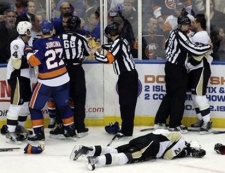 Pittsburgh Penguins' Eric Tangradi lies on the ice during a fight against the New York Islanders in the third period of an NHL game, Friday, Feb. 11, 2011, in Uniondale, N.Y. The Islanders won 9-3.(AP Photo/Mark Lennihan) 