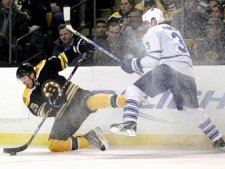 Boston Bruins right wing Blake Wheeler, left, controls the puck against Toronto Maple Leafs defenceman Dion Phaneuf in an NHL game in Boston on Tuesday, Feb. 15, 2011. (AP Photo/Elise Amendola)