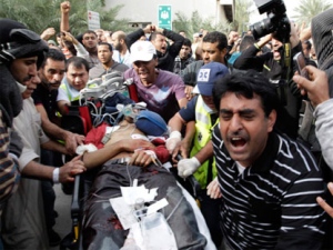 A Bahraini anti-government demonstrator lies injured on a stretcher as Bahraini anti-government demonstrators take him to hospital in Manama, Bahrain, early Thursday morning, Feb. 17, 2011. (AP / Hassan Ammar)