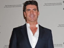 Simon Cowell poses at the 38th International Emmy Awards on Monday, Nov. 22, 2010, in New York. (AP Photo/Louis Lanzano)