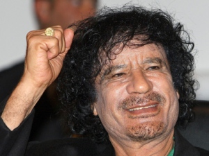 Libyan leader Col. Moammar Gadhafi gestures while visiting the UNESCO headquarters on the second day of his six-day visit in Paris in this Tuesday, Dec. 11, 2007, photo. (AP Photo/Jacky Naegelen)