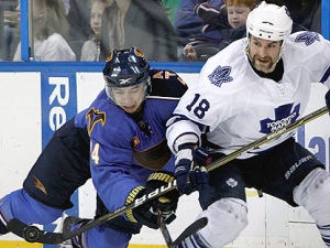 Toronto Maple Leafs left wing Mike Brown (18) plays the puck against Atlanta Thrashers center Tim Stapleton (14) during the third period of an NHL hockey game Sunday, Feb. 27, 2011, in Atlanta. Atlanta won 3-2. (AP Photo/David Goldman)