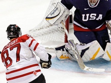 Canada's Sidney Crosby (87) shoots past USA goalie Ryan Miller (39) for the game-winning goal in the overtime period of a men's gold medal ice hockey game at the Vancouver 2010 Olympics in Vancouver, British Columbia, Sunday, Feb. 28, 2010. (AP Photo/Chris O'Meara)