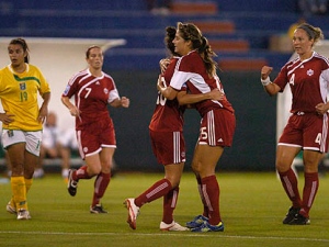 Canada's Christine Julien, front right, celebrates with teammate Kara Lang after scoring a goal against Guyana at a 2010 Women's World Cup qualifier soccer match in Cancun, Mexico, Sunday Oct. 31, 2010. (AP Photo/Israel Leal)