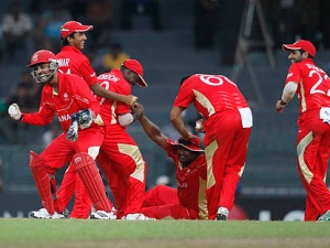 Canada's captain Ashish Bagai, front left, and team members celebrate the dismissal of Pakistan batsman Abdul Razzaq, unseen, during the ICC Cricket World Cup match between Canada and Pakistan in Colombo, Sri Lanka, Thursday, March 3, 2011.(AP Photo/ Eranga Jayawardena)