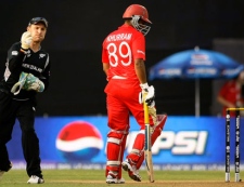 New Zealand's Brendon McCullum, left, goes to throw the ball during their Cricket World Cup match against Canada in Mumbai, India, Sunday, March 13, 2011. (AP Photo/Rajanish Kakade)