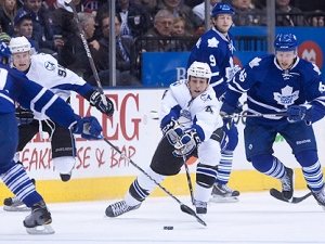 Tampa Bay Lightning's Vincent Lecavalier, centre, and Steven Stamkos, second from left, battle for the puck with Toronto Maple Leafs, from left to right, Keith Aulie, Colby Armstrong, and Joey Crabb during first period NHL hockey action in Toronto Monday, March 14, 2011. (THE CANADIAN PRESS/Darren Calabrese)
