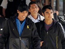  In this Wednesday, Sept. 1, 2010 file photo Pakistan cricket players Mohammad Amir, left, Salman Butt, right, and Mohammad Asif, centre rear, walk to a taxi flanked by security men, as they leave their hotel in Taunton, England.