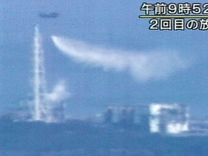 In this photo made off NHK TV video footage, a Japan Self-Defense Force helicopter dumps water over the No. 3 unit of the Fukushima Dai-ichi nuclear power plant in Okumamachi, Fukushima Prefecture, Thursday, March 17, 2011. The Japanese caption reads: "9:52 a.m. Second discharge of water." (AP Photo/NHK TV) 