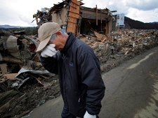 Katsuo Maiya, 73, cries in front of the rubble where his sister-in-law's house stood in Rikuzentakata, Iwate Prefecture, northern Japan, Thursday, March 17, 2011. Maiya's sister-in-law and her husband were killed in Friday's earthquake and tsunami. (AP Photo/Itsuo Inouye)