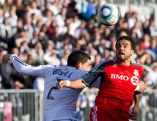 Vancouver Whitecaps' Michael Boxall, left, and Toronto FC's Dwayne De Rosario fight for control of the ball during the second half of an MLS soccer game in Vancouver, B.C., on Saturday March 19, 2011.  THE CANADIAN PRESS/Jonathan Hayward