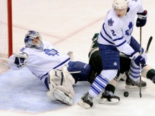 Toronto Maple Leafs goalie James Reimer falls as he and Luke Schenn stop a scoring attempt by Minnesota Wild forward Eric Nystrom during an NHL game Tuesday, March 22, 2011, in St. Paul, Minn. (AP Photo/Jim Mone)