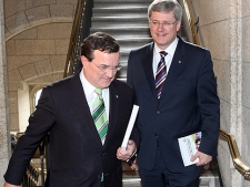 Finance Minister Jim Flaherty and Prime Minister Stephen Harper make their way to the House of Commons to deliver the federal budget on Parliament Hill in Ottawa on Tuesday March 22, 2011. (THE CANADIAN PRESS/Fred Chartrand)