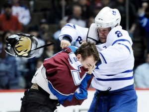 Toronto Maple Leafs defenceman Mike Komisarek, right, fights with Colorado Avalanche player Cameron Gaunce during an NHL game Thursday, March 24, 2011, in Denver. (AP Photo/Jack Dempsey)