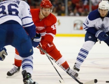 Detroit Red Wings center Darren Helm (43) skates with the puck against Toronto Maple Leafs defenseman Carl Gunnarsson (36), from Sweden, in the third period of an NHL hockey game in Detroit, Saturday, March 26, 2011. Detroit won 4-2. (AP Photo/Rick Osentoski)