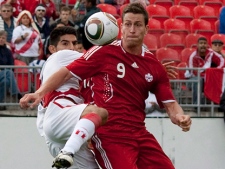 Canada's Rob Friend tries to turn Peru's Carlos Zambrano during first half international friendly soccer action in Toronto on Saturday, Sept. 4, 2010. (THE CANADIAN PRESS/Chris Young)