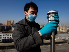 A worker examines a device used to test the air for radiation at a monitoring station in Harbin in northeast China's Heilongjiang province Tuesday March 29, 2011. Chinese authorities say trace amounts of atmospheric radiation from Japan's stricken nuclear power plant have been detected in more parts of China. (AP Photo) 