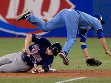 Toronto Blue Jays' John McDonald (right) collides with Minnesota Twins' Justin Morneau at second base after Twins' Michael Cuddyer grounds into fielder's choice during eight inning MLB baseball action in Toronto Wednesday, July 7, 2010. THE CANADIAN PRESS/Chris Young