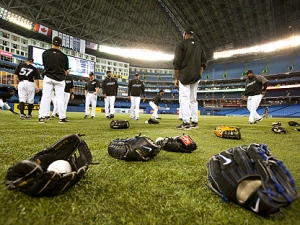 Baseball gloves litter the field as the Toronto Blue Jays participate in the team's first workout at the Roger Centre in Toronto Thursday, 31, 2011. (THE CANADIAN PRESS/Darren Calabrese)