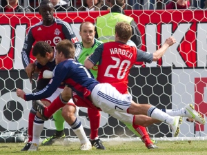 Chivas USA's Justin Braun (centre) dives in front of teammate Alejandro Moreno and Toronto FC's Daneigh Borman (back left) and Ty Harden (right) to send a header towards Toronto goalkeeper Stefan Frei (centre rear) during second half MLS action in Toronto on Saturday April 2, 2011. (THE CANADIAN PRESS/Chris Young)