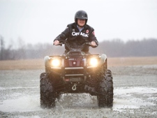 Prime Minister Stephen Harper rides an ATV during a camapign stop on a farm in Wainfleet, Ont., on Monday, April 4, 2011. (THE CANADIAN PRESS/Sean Kilpatrick)