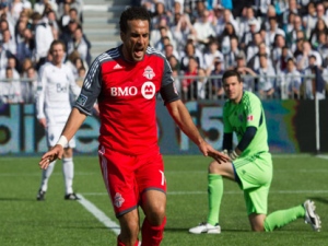 Toronto FC's Dwayne De Rosario, centre, celebrates his goal as Vancouver Whitecaps goalie Jay Nolly, right, looks on during the first half of an MLS soccer game in Vancouver, B.C., on Saturday March 19, 2011. (THE CANADIAN PRESS/Darryl Dyck)